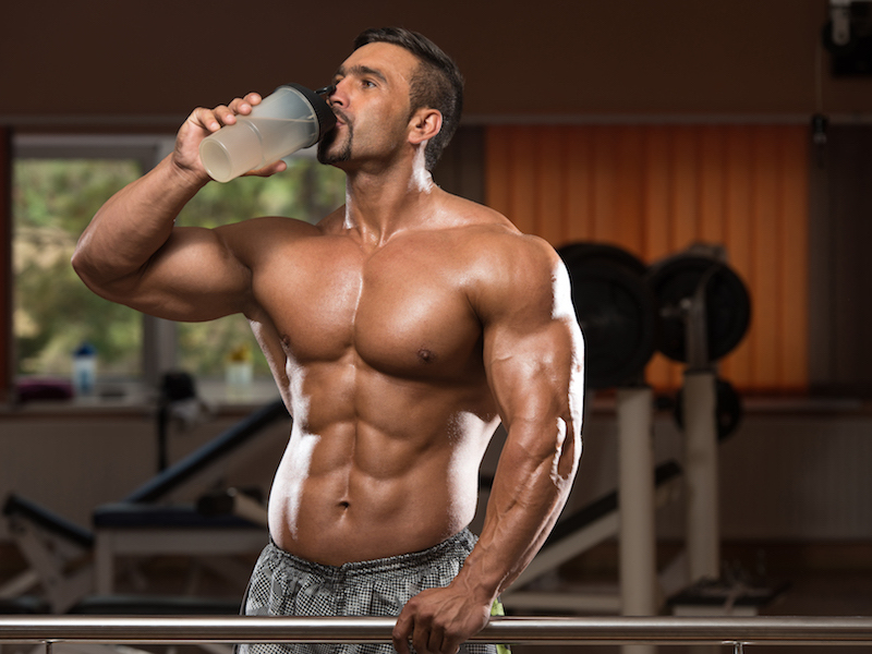 Muscular Man Drinking A Water Bottle